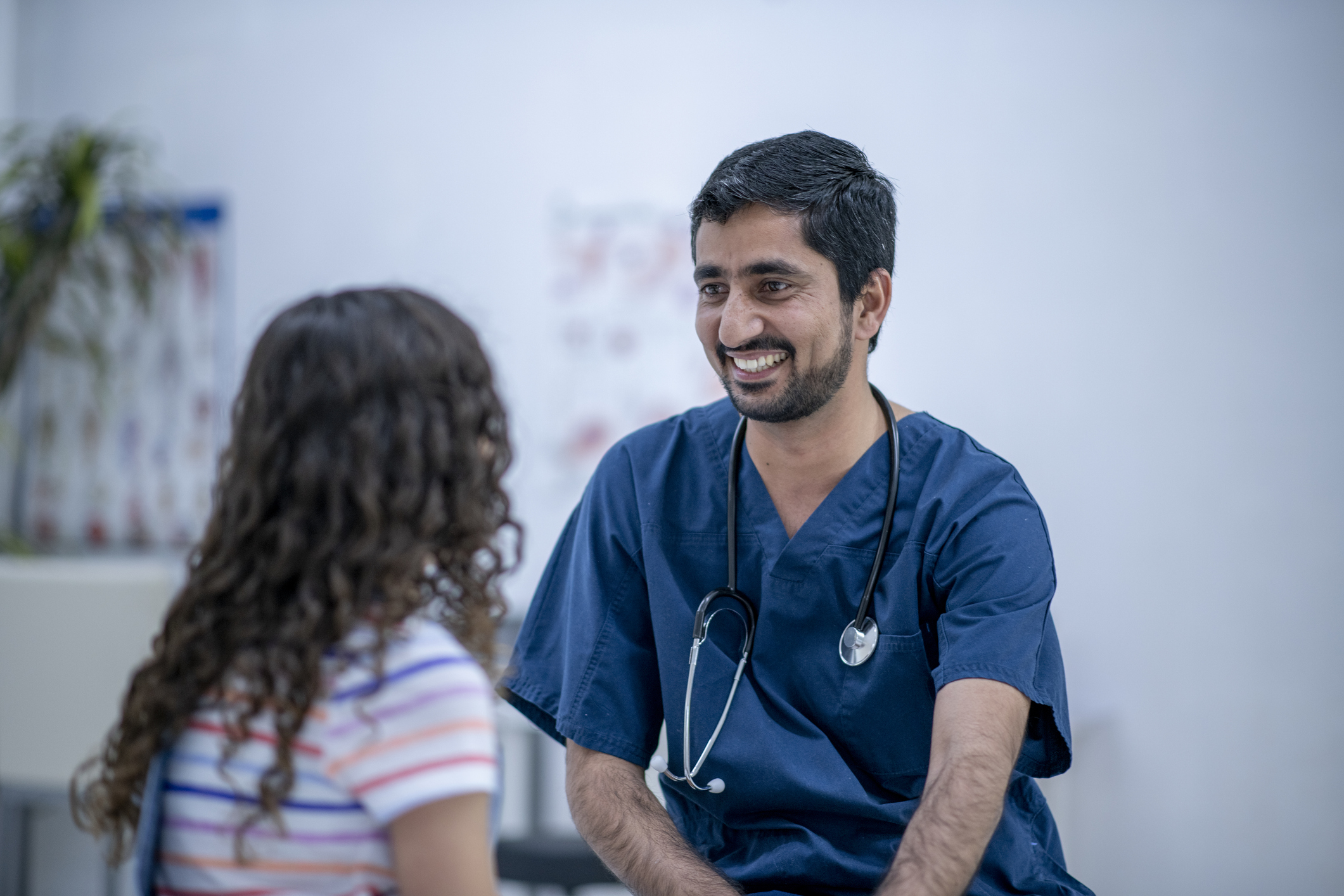 Provider smiling while speaking with a patient